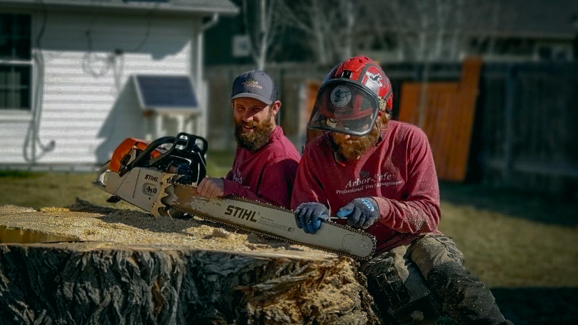 James and John sharpening a chainsaw blade
